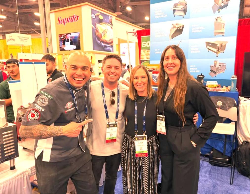 Joe Stubbe and his wife Allison standing with two pizza-industry friends at a trade show.